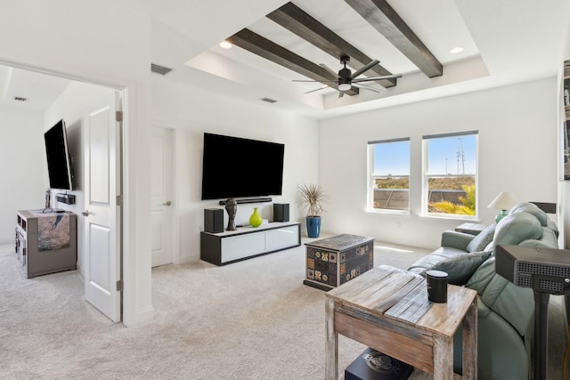 living area with visible vents, beam ceiling, a ceiling fan, carpet, and a raised ceiling