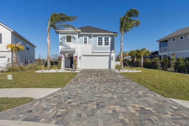 raised beach house featuring a garage, decorative driveway, a front yard, and fence