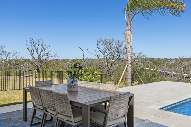 view of patio / terrace with a fenced in pool, outdoor dining space, and fence