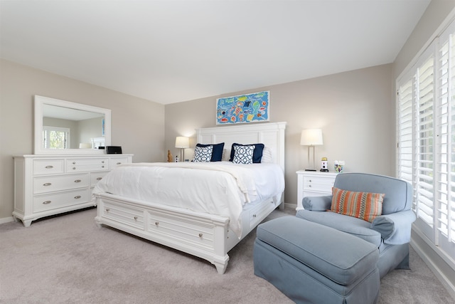 carpeted bedroom with multiple windows