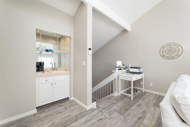 office space featuring light hardwood / wood-style flooring, high vaulted ceiling, and sink