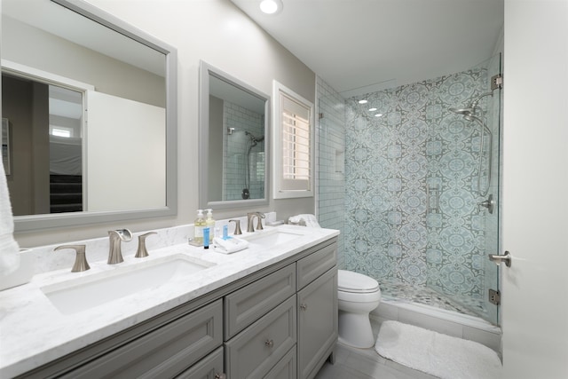 bathroom featuring vanity, toilet, and walk in shower