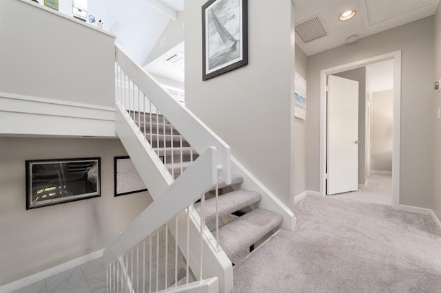 staircase with carpet and vaulted ceiling