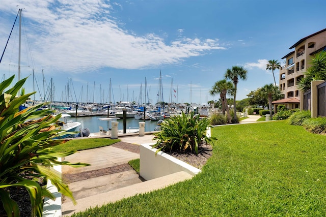 dock area featuring a lawn and a water view