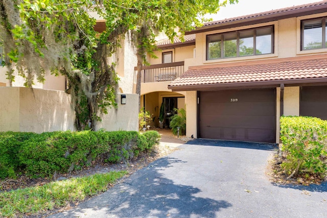 view of front of home featuring a balcony and a garage