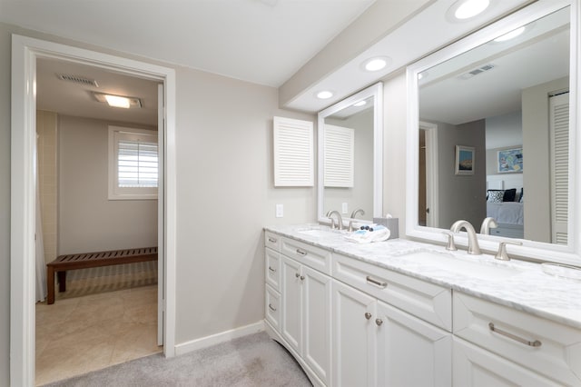 bathroom with tile patterned flooring and vanity