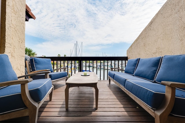 deck featuring an outdoor hangout area and a water view