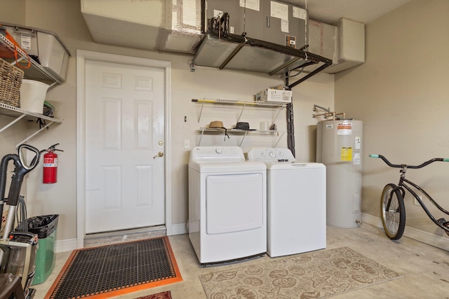 laundry room with electric water heater and washing machine and clothes dryer