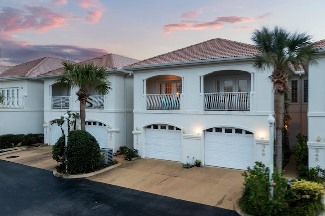 view of front of home featuring a balcony and central AC