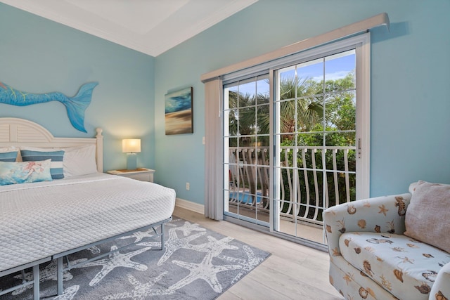 bedroom with access to exterior, crown molding, and light hardwood / wood-style flooring