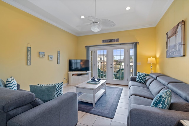 living room with ceiling fan, light tile patterned flooring, ornamental molding, and french doors