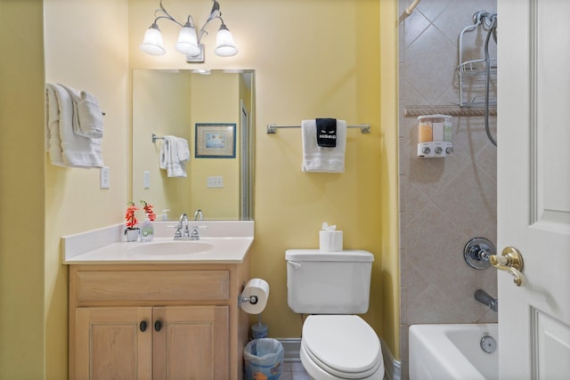 full bathroom with toilet, vanity, and tiled shower / bath