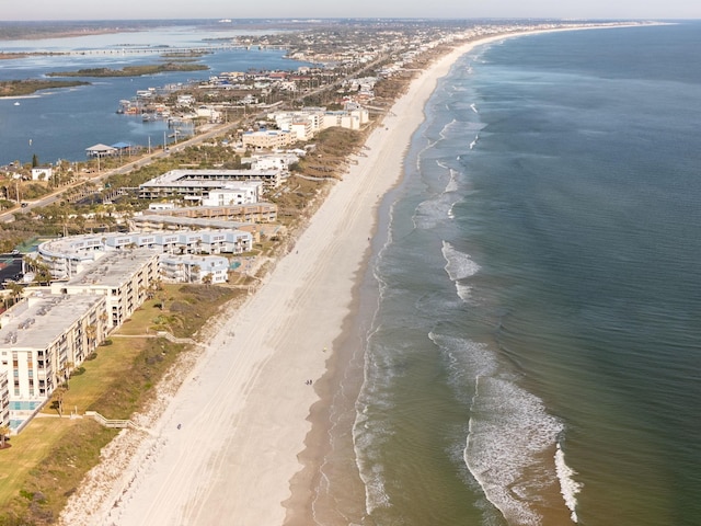 birds eye view of property with a view of the beach and a water view