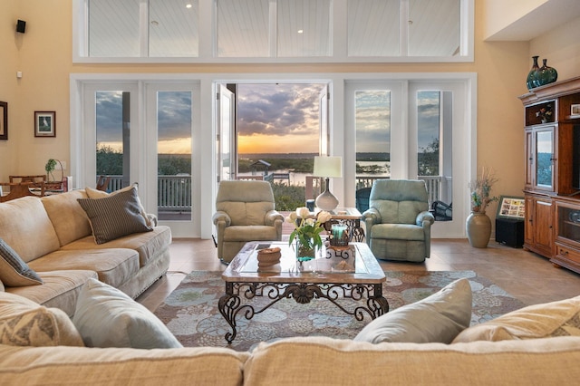 tiled living room featuring a high ceiling