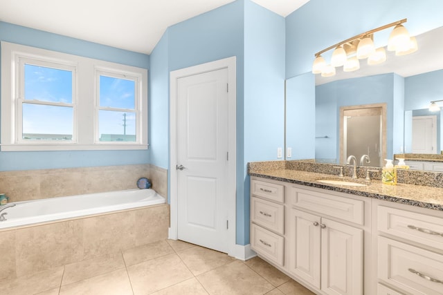 bathroom featuring vanity, tiled bath, and tile patterned floors