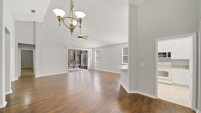 unfurnished living room featuring a textured ceiling, ceiling fan with notable chandelier, high vaulted ceiling, and wood-type flooring