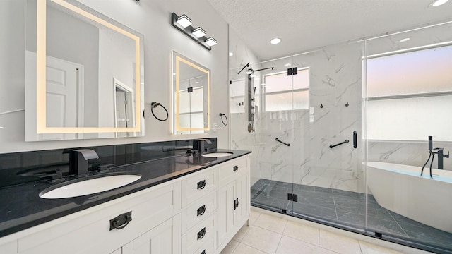 bathroom with plus walk in shower, vanity, and a textured ceiling