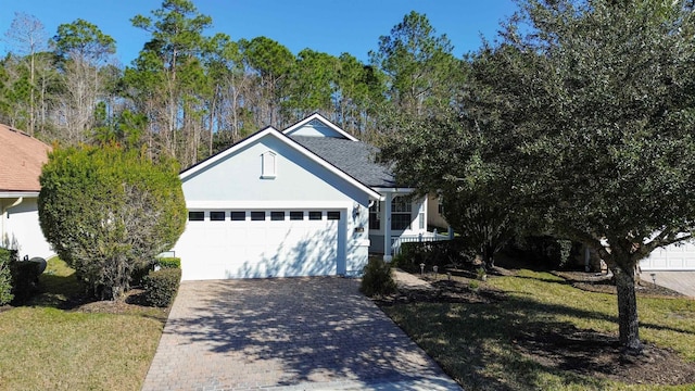 view of front of property with a front lawn and a garage