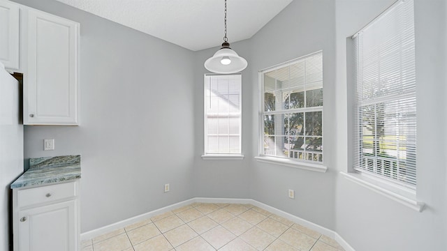 unfurnished dining area featuring light tile patterned floors