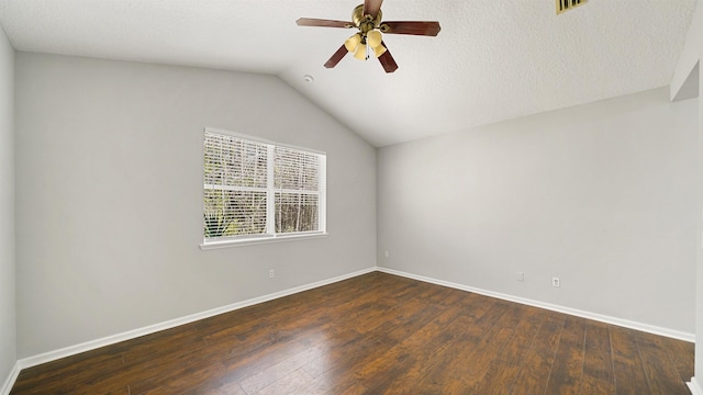 spare room featuring ceiling fan, vaulted ceiling, dark hardwood / wood-style flooring, and a textured ceiling