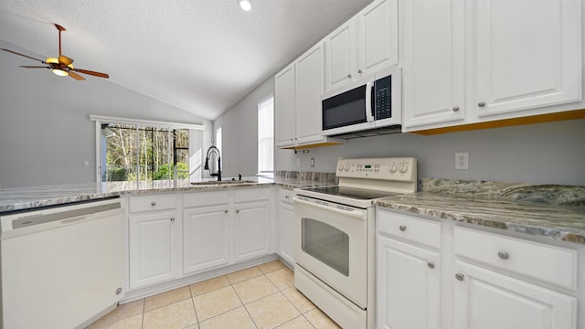 kitchen with white appliances, white cabinetry, and sink