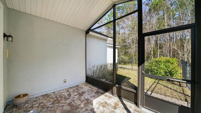 unfurnished sunroom with vaulted ceiling