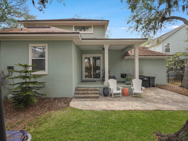 847 Tides End Dr, Saint Augustine, FL 32080 - back of property with stucco siding, fence, a ceiling fan, and a patio
