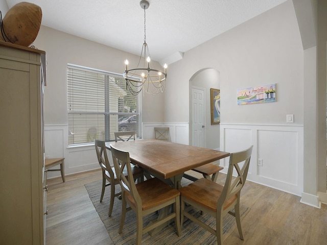 847 Tides End Dr, Saint Augustine, FL 32080 - dining space featuring arched walkways, light wood-style flooring, and a decorative wall