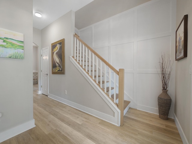 847 Tides End Dr, Saint Augustine, FL 32080 - stairway with wood finished floors, a decorative wall, and baseboards