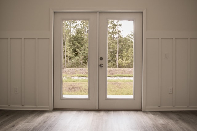 4350 Theresa St, Hastings, FL 32145 - entryway with french doors, a decorative wall, light wood finished floors, plenty of natural light, and wainscoting