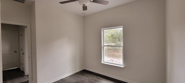 unfurnished room featuring ceiling fan, dark hardwood / wood-style flooring, and a wealth of natural light