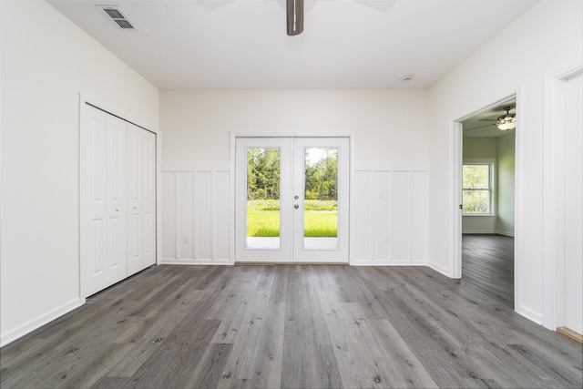 4350 Theresa St, Hastings, FL 32145 - unfurnished bedroom featuring access to outside, french doors, wood finished floors, a ceiling fan, and wainscoting