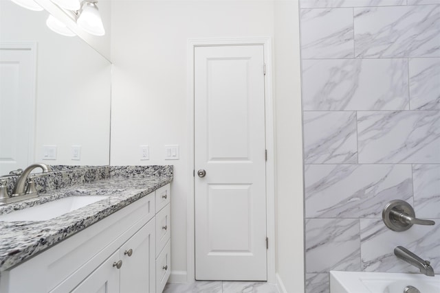 bathroom featuring vanity and tiled shower / bath combo