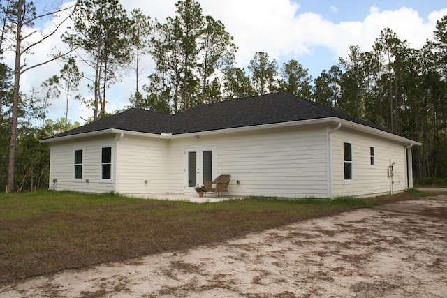 4350 Theresa St, Hastings, FL 32145 - rear view of property featuring french doors, a patio area, and a shingled roof
