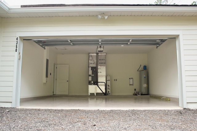 garage with electric water heater and a garage door opener