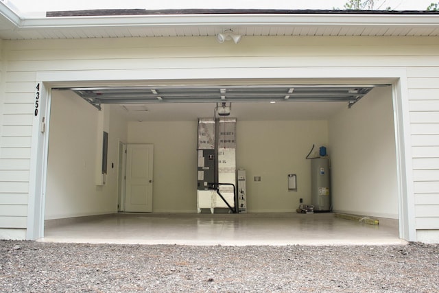 4350 Theresa St, Hastings, FL 32145 - garage with electric water heater, a garage door opener, and heating unit