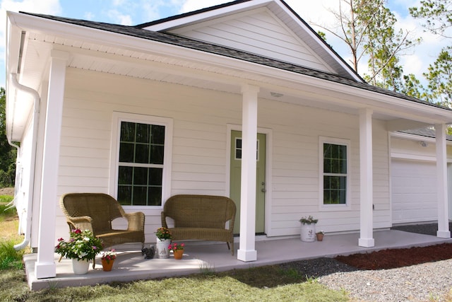 exterior space featuring covered porch and a garage