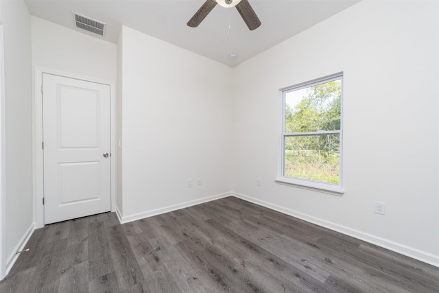 spare room featuring dark hardwood / wood-style flooring and ceiling fan