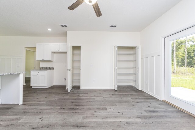 unfurnished living room with ceiling fan and light wood-type flooring