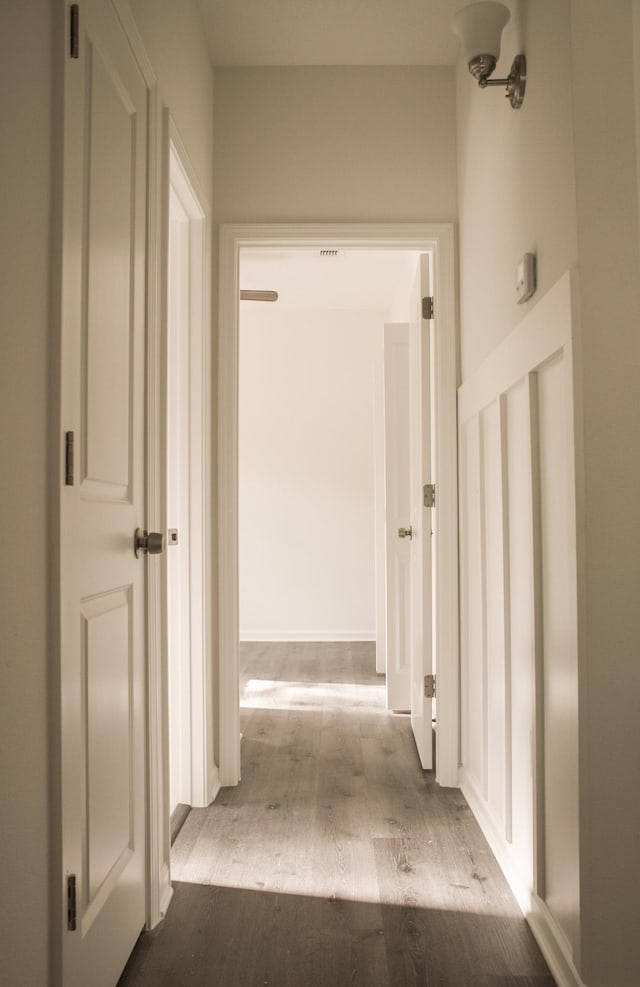 hallway with light hardwood / wood-style floors