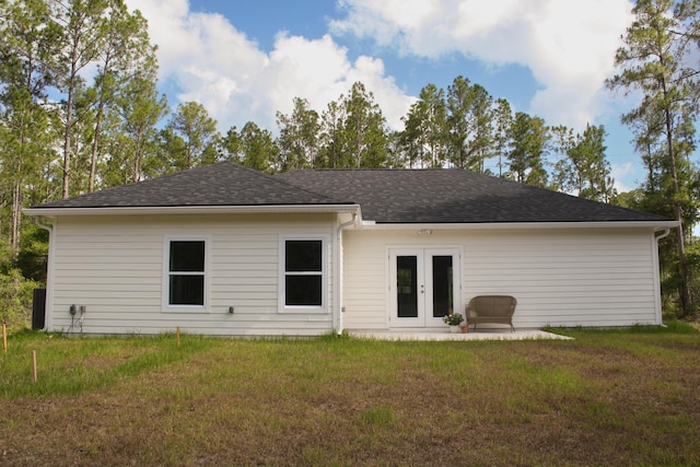 rear view of property featuring a yard and french doors