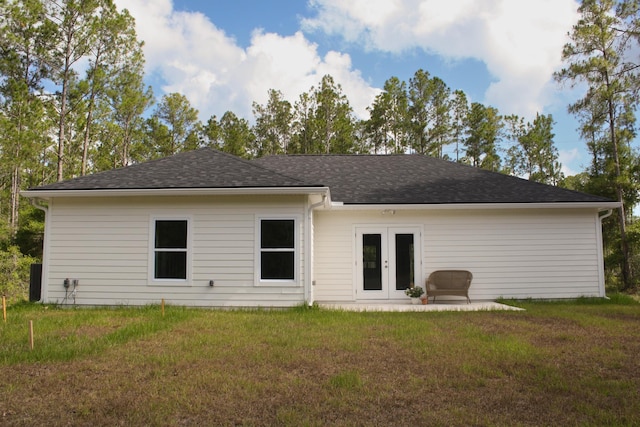4350 Theresa St, Hastings, FL 32145 - rear view of property with a lawn, french doors, and a shingled roof