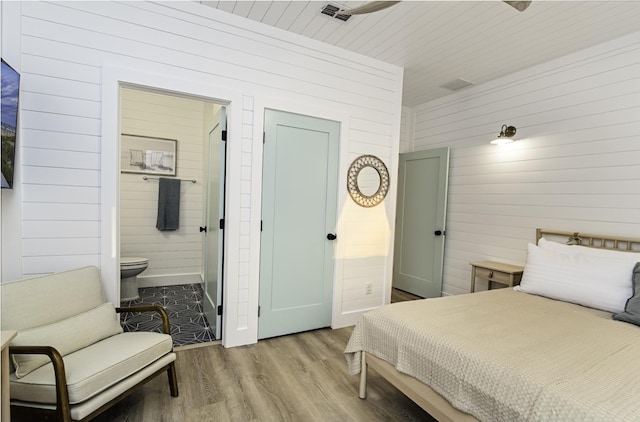 16/18/20 Inlet Pl, Saint Augustine, FL 32080 - bedroom featuring wood walls, wood finished floors, and ensuite bath