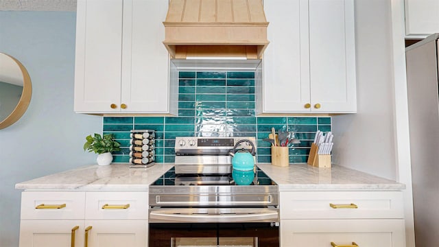 16/18/20 Inlet Pl, Saint Augustine, FL 32080 - kitchen featuring stainless steel range with electric cooktop, backsplash, light stone counters, and white cabinetry