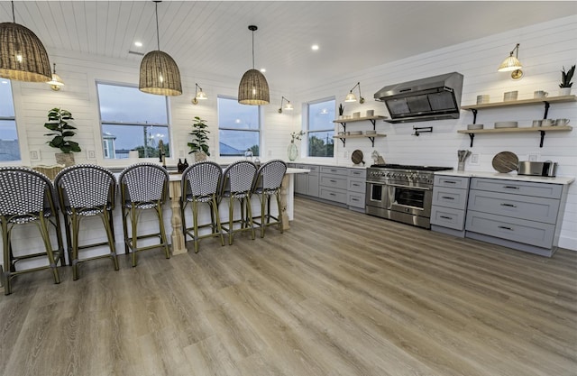 16/18/20 Inlet Pl, Saint Augustine, FL 32080 - kitchen featuring gray cabinets, double oven range, open shelves, wall chimney exhaust hood, and recessed lighting