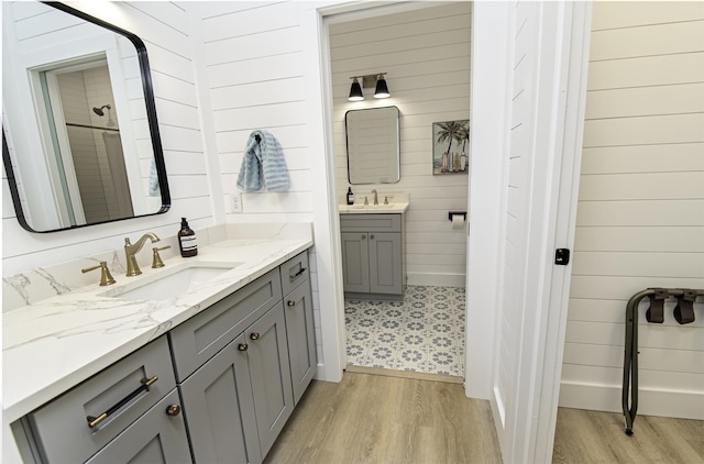 16/18/20 Inlet Pl, Saint Augustine, FL 32080 - full bathroom featuring wood finished floors, two vanities, and wood walls