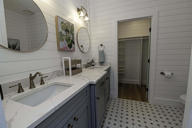 16/18/20 Inlet Pl, Saint Augustine, FL 32080 - full bath with tile patterned floors, wood walls, double vanity, a walk in closet, and toilet