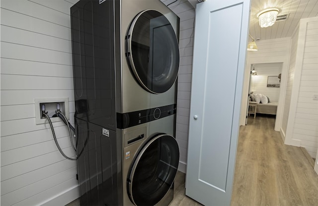 16/18/20 Inlet Pl, Saint Augustine, FL 32080 - clothes washing area with stacked washer / drying machine, wood finished floors, and wooden walls