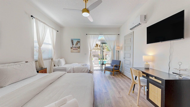 16/18/20 Inlet Pl, Saint Augustine, FL 32080 - bedroom featuring an AC wall unit, access to exterior, light wood finished floors, and ceiling fan