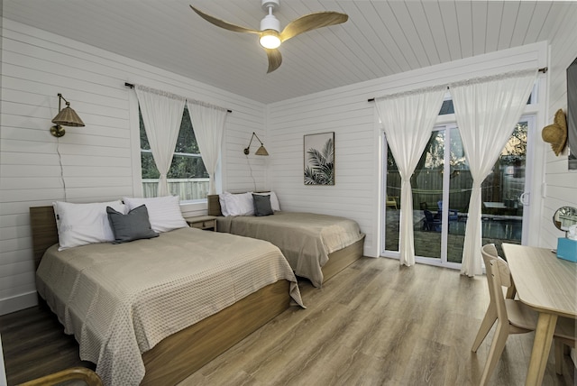 16/18/20 Inlet Pl, Saint Augustine, FL 32080 - bedroom with wooden walls, access to exterior, wood finished floors, and a ceiling fan